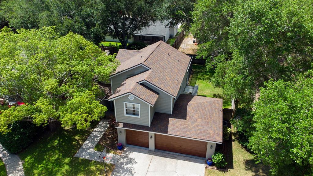 An aerial view of a two-story house with a two-car garage and a shingled roof — 1564 COLONY COURT, PALM HARBOR, FL