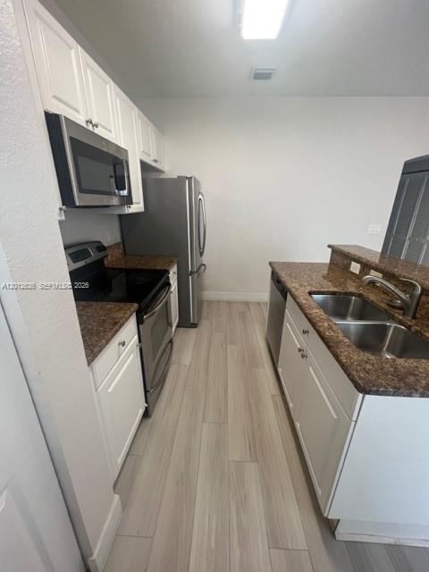 A kitchen features white cabinetry, stainless steel appliances, and brown granite countertops — 2573 SW 121st Ter # 2003, Miramar FL 33025, MIRAMAR, FL