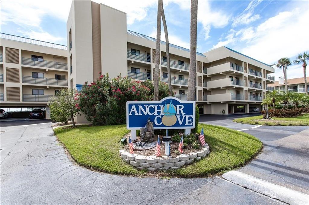 A sign for Anchor Cove stands in front of a multi-story apartment building — 363 PINELLAS BAYWAY S UNIT 50, TIERRA VERDE, FL