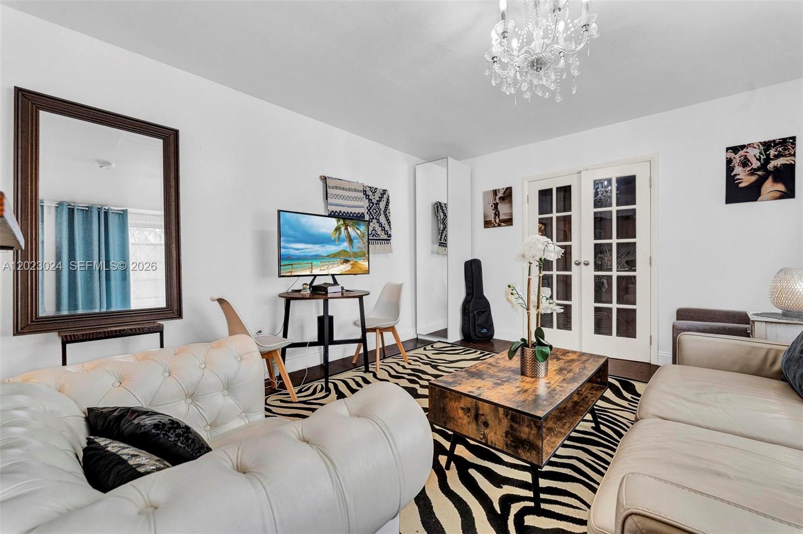 A living room features a zebra-print rug, a tufted white sofa, and a coffee table — 1150 Euclid Ave # 101, Miami Beach FL 33139, MIAMI BEACH, FL