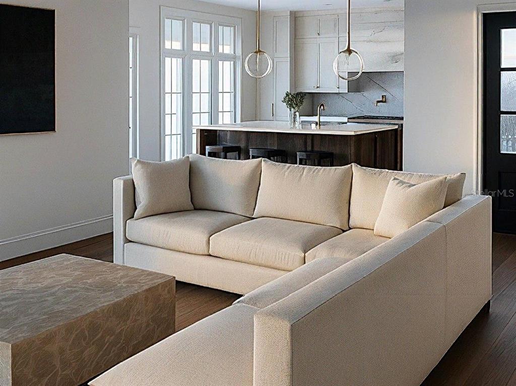 A modern living room features a beige sectional sofa, a textured coffee table, and kitchen island — 149 W WILBUR AVENUE UNIT 105, LAKE MARY, FL