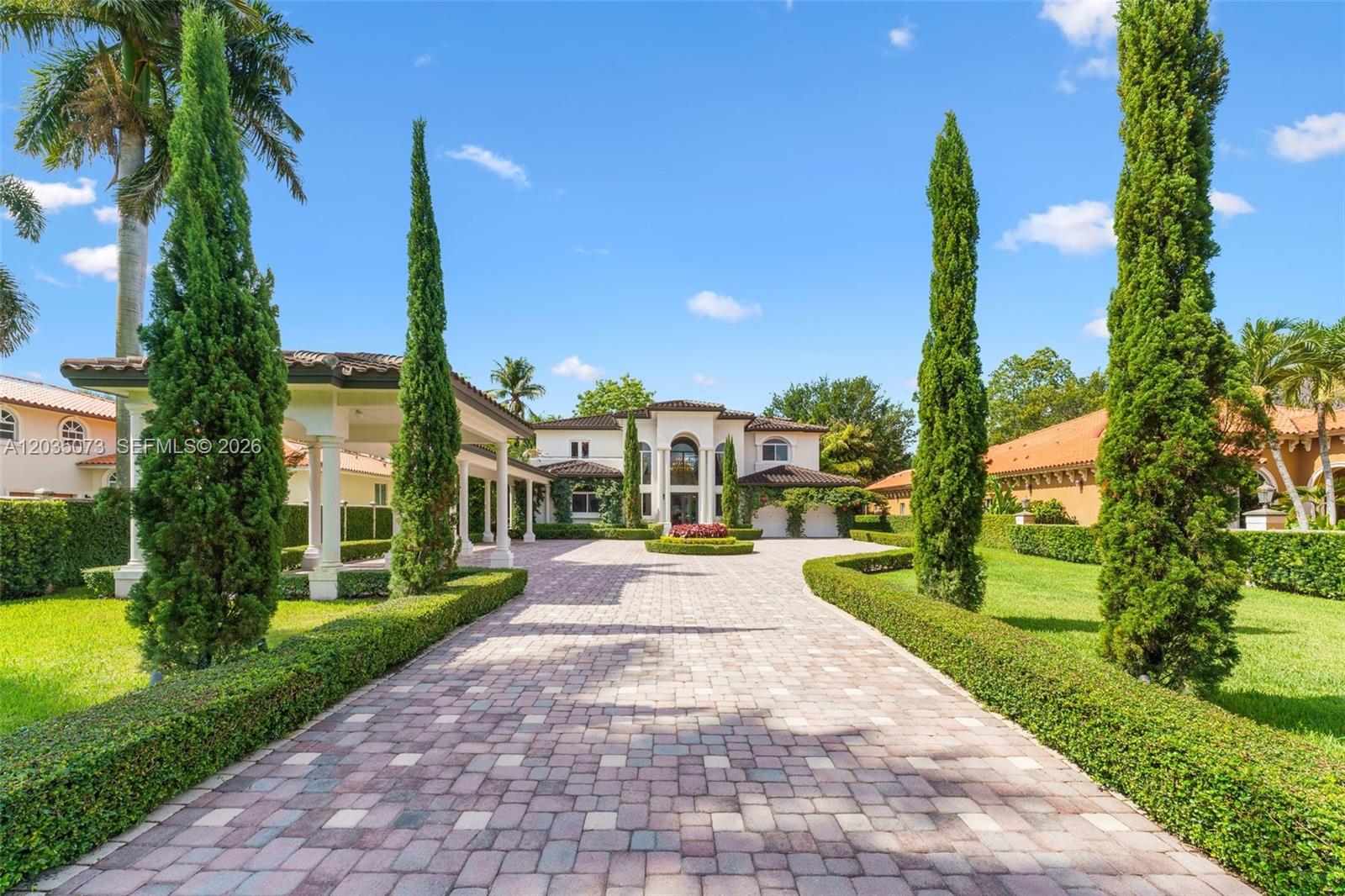 A paved driveway leads to a large two-story house with manicured hedges and tall trees — 13470 SW 32nd St, Miami FL 33175, MIAMI, FL