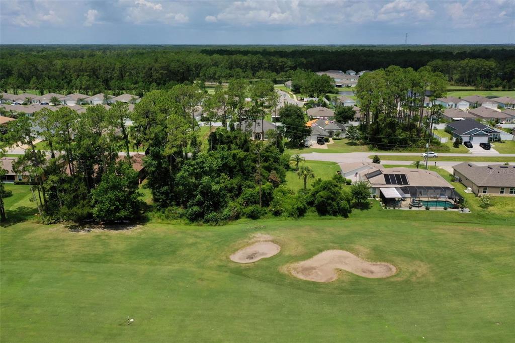 An aerial view of a golf course fairway with sand traps and surrounding residential homes — 93 EDWARD DRIVE, PALM COAST, FL