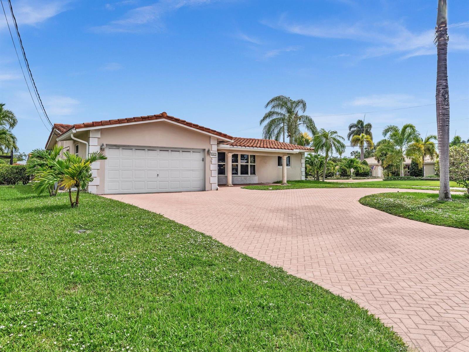 A single-story house with a tiled roof, garage, and paved driveway surrounded by palm trees — 641 SE 11th Street, Pompano Beach FL 33060, POMPANO BEACH, FL