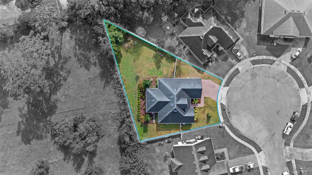 An aerial view shows a house on a triangular lot bordered by a cul-de-sac — 510 CODY ALLEN COURT, ST CLOUD, FL