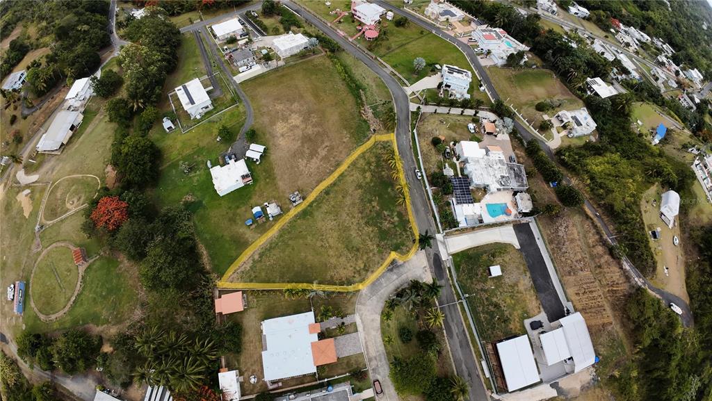 An aerial view shows a vacant, irregularly shaped lot outlined in yellow within a residential neighborhood — PR 985 QUEBRADA FAJARDO UNIT 4F, FAJARDO, PR