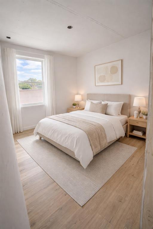 A bedroom with a queen bed, two nightstands, a window with curtains, and wood flooring — 4517 AMERICA STREET, ORLANDO, FL
