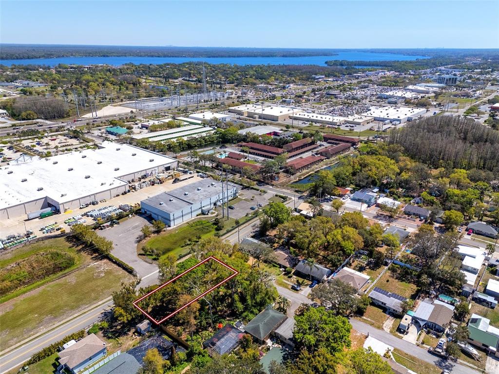 An aerial view shows a rectangular vacant lot outlined in red within a residential neighborhood — BOSTON STREET, TARPON SPRINGS, FL