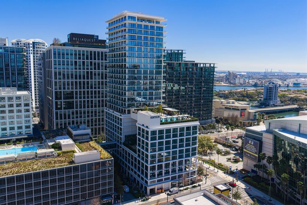 An aerial view of a modern high-rise building with a rooftop pool in a city — 1000 WATER STREET UNIT 1502, TAMPA, FL