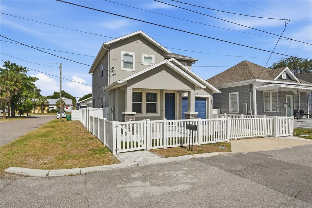 A two-story house with a white picket fence and a blue front door — 2904 BANZA STREET, TAMPA, FL