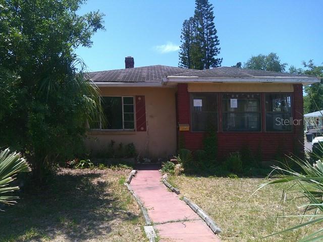 A single-story house with a red-painted exterior and a red walkway leading to the entrance — 2040 22ND AVENUE S, ST PETERSBURG, FL
