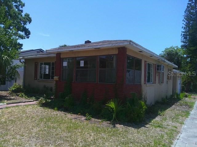 A single-story house with a red brick facade and a flat roof — 2040 22ND AVENUE S, ST PETERSBURG, FL
