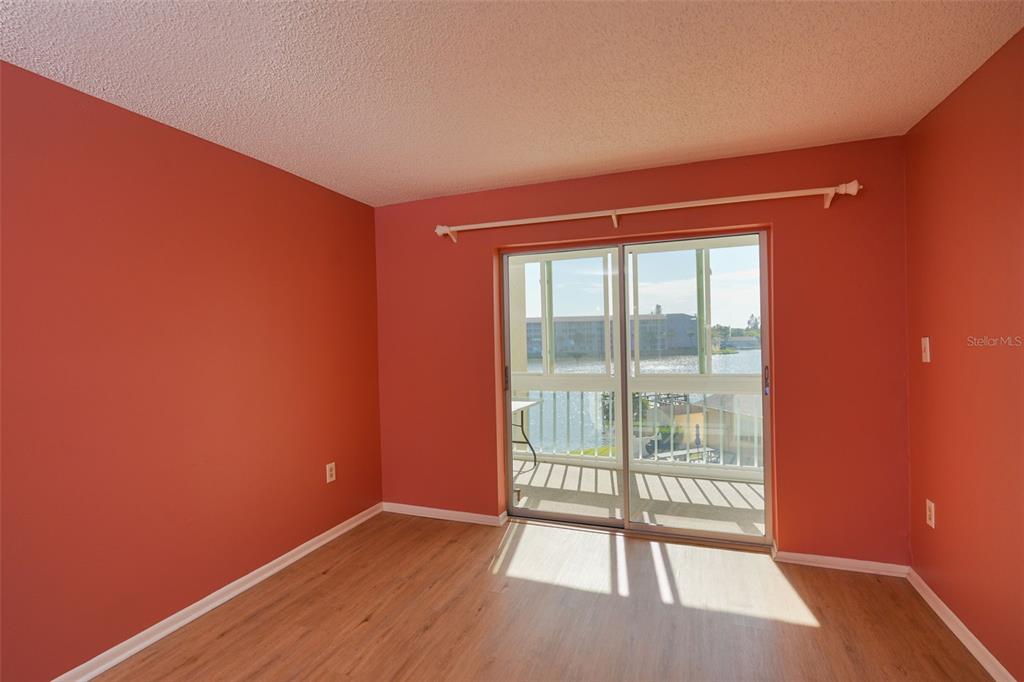 A multi-story apartment building with exterior walkways and a parking lot in the foreground — 3607 LAKE BAYSHORE DRIVE UNIT 312, BRADENTON, FL