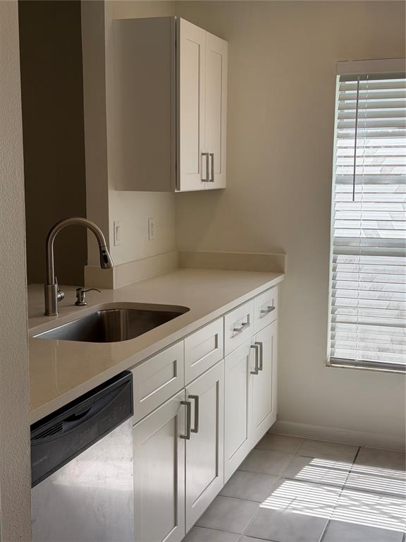 A kitchen features white cabinets, a stainless steel sink, a dishwasher, and a window — 518 BRYAN VALLEY COURT, BRANDON, FL