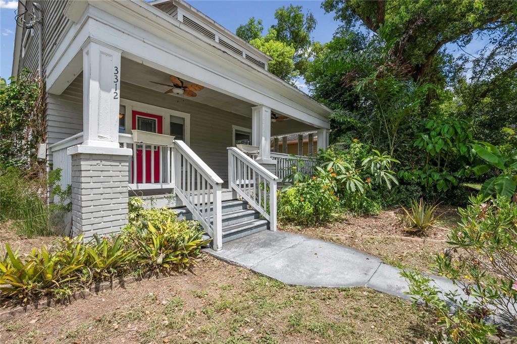 A single-story house with a front porch, gray siding, and a red front door — 3312 N JEFFERSON STREET, TAMPA, FL