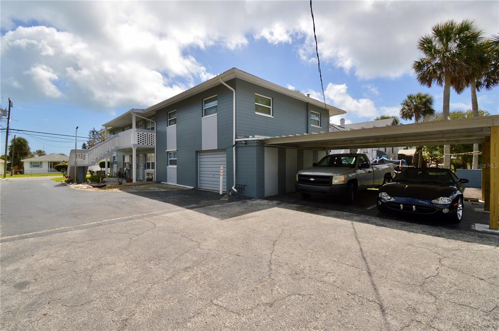 A two-story gray building with a carport, a garage, and a paved parking lot — 835 N GRANDVIEW AVENUE, DAYTONA BEACH, FL