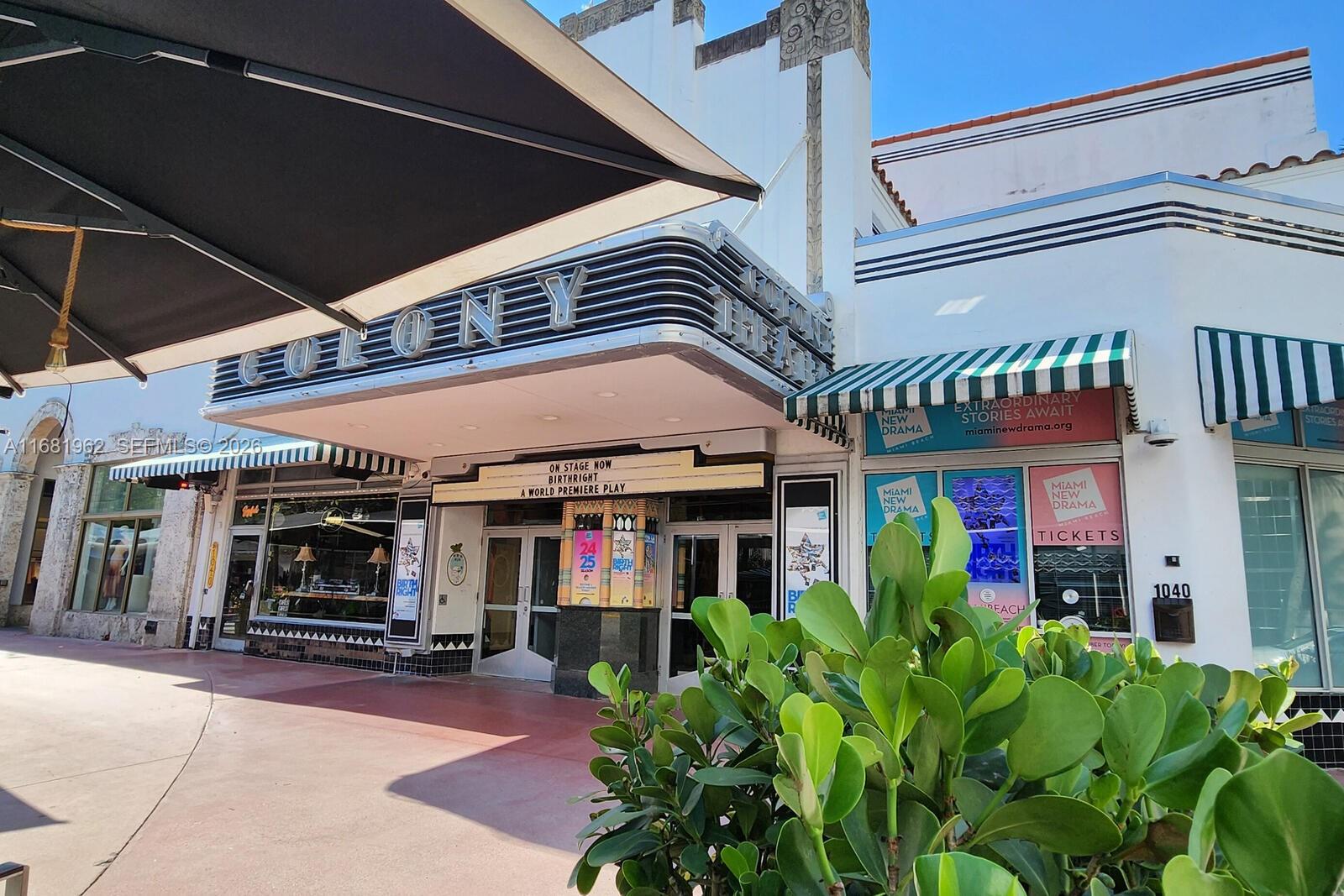 The exterior of the Colony Theatre features an Art Deco marquee and a green-striped awning — 1300 Lincoln Rd # A701, Miami Beach FL 33139, MIAMI BEACH, FL