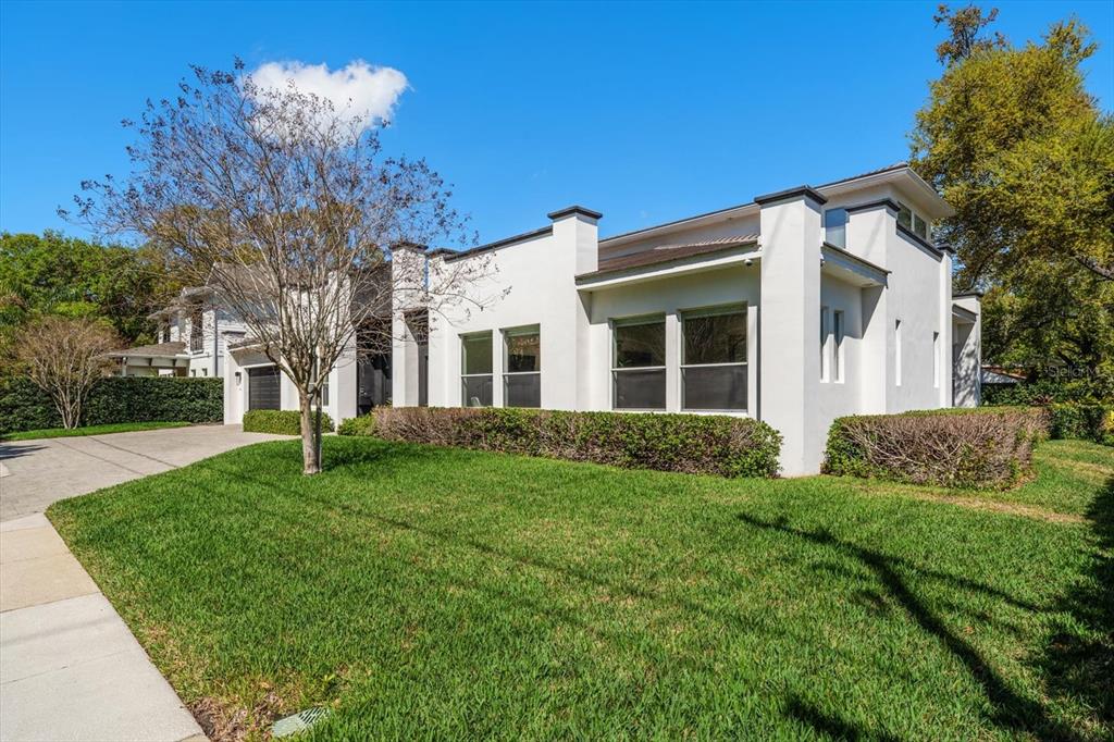 A white, modern two-story house with a manicured lawn and a paved driveway — 3901 W GRANADA STREET, TAMPA, FL