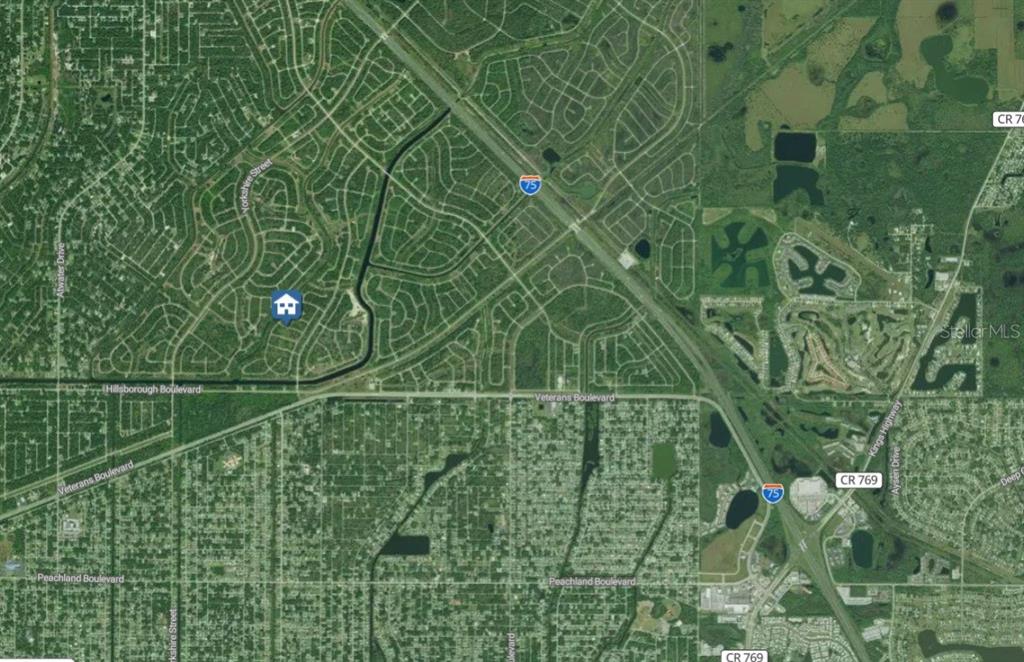 This is a satellite map showing a residential area with a house icon marker — Lot 13 SKINNER LANE, NORTH PORT, FL