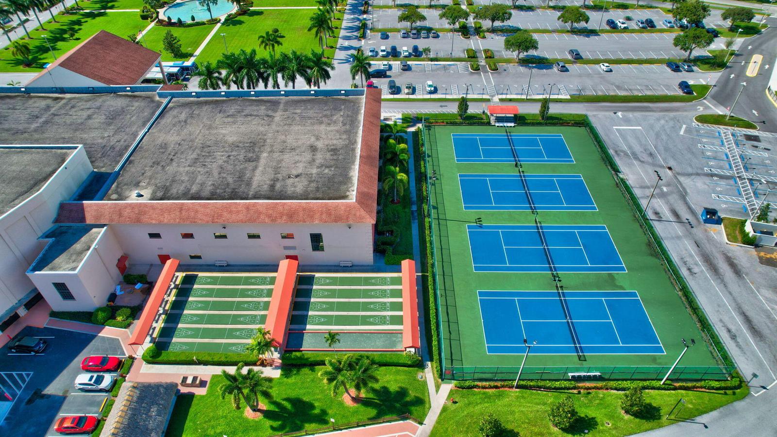 An aerial view shows a building with shuffleboard courts and three blue tennis courts nearby — 3008 Rexford, Boca Raton FL 33434, BOCA RATON, FL