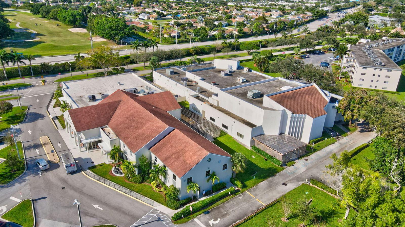 An aerial view shows a commercial building with a red-tiled roof and adjacent parking lots — 3008 Rexford, Boca Raton FL 33434, BOCA RATON, FL