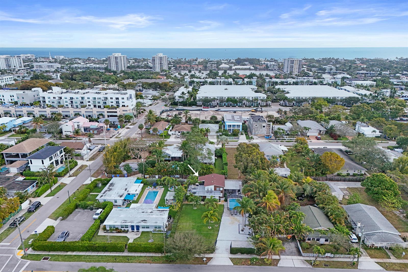 An aerial view shows a residential neighborhood with houses, swimming pools, and palm trees — 311 SE 3rd Avenue, Delray Beach FL 33483, DELRAY BEACH, FL