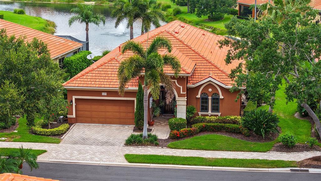 An aerial view of a single-story house with a terracotta tile roof and garage — 5157 COTE DU RHONE WAY, SARASOTA, FL