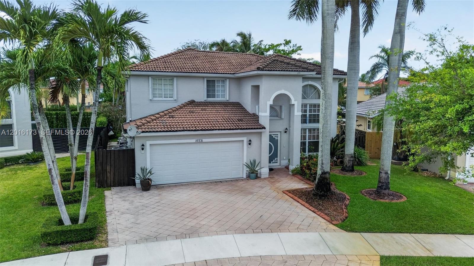 A two-story house with a tile roof, a two-car garage, and a paved driveway — 10331 SW 164th Ct, Miami FL 33196, MIAMI, FL