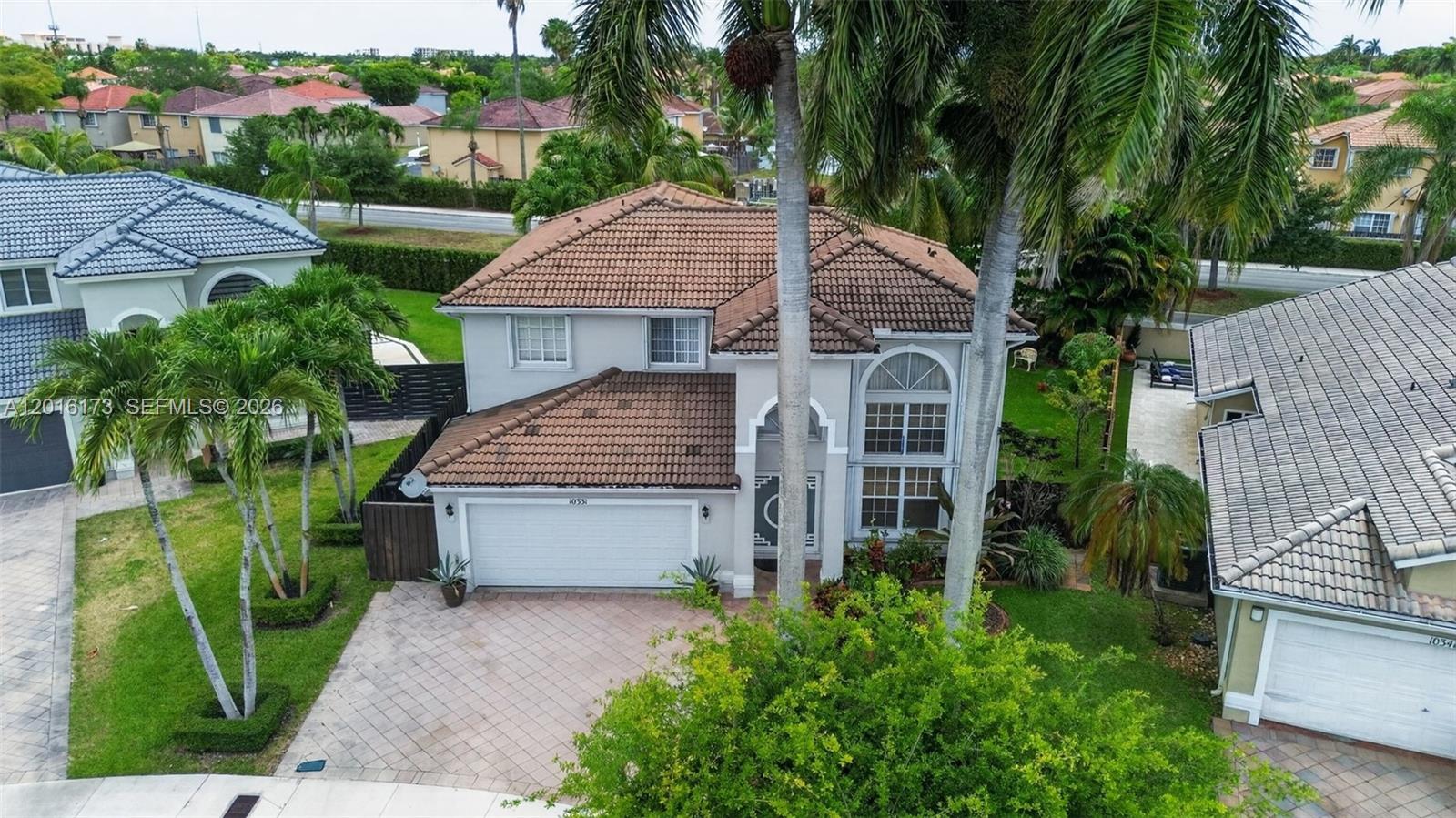 An aerial view shows a two-story house with a tiled roof and a paved driveway — 10331 SW 164th Ct, Miami FL 33196, MIAMI, FL