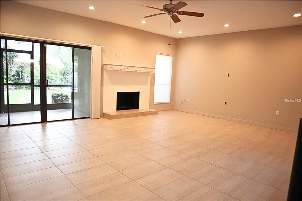 A brick walkway leads to the front entrance of a house with a tile roof — 4820 KESTRAL PARK CIRCLE UNIT 18, SARASOTA, FL