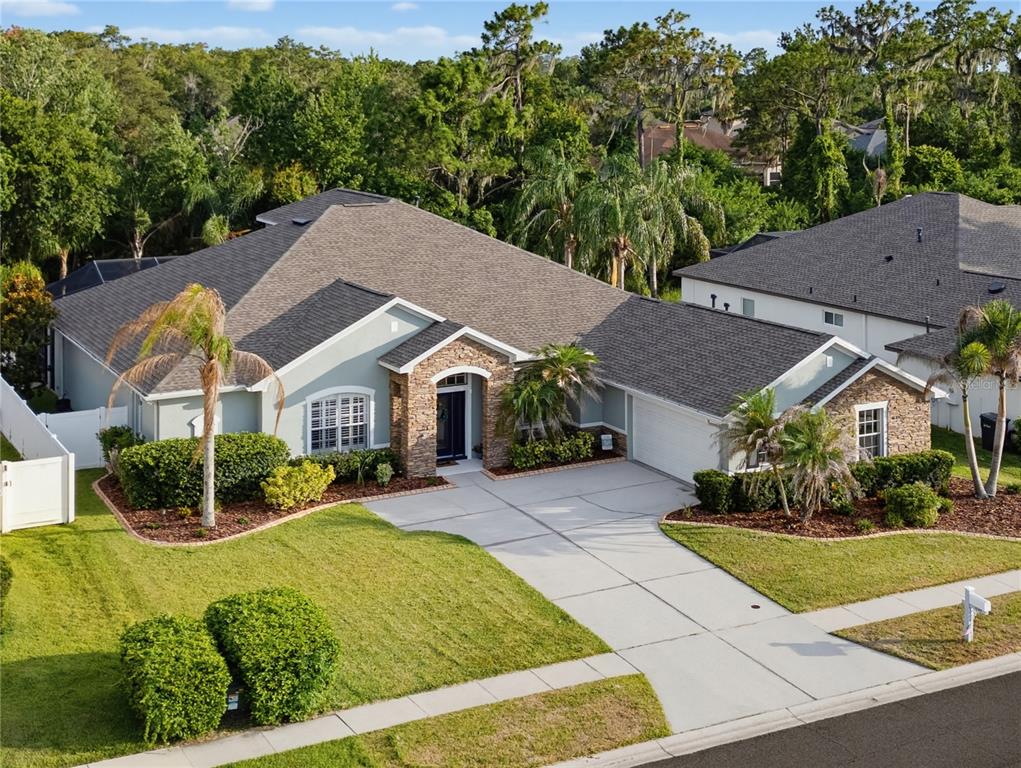 An aerial view of a single-story house with a stone entryway and a concrete driveway — 11704 NEWBERRY GROVE LOOP, RIVERVIEW, FL