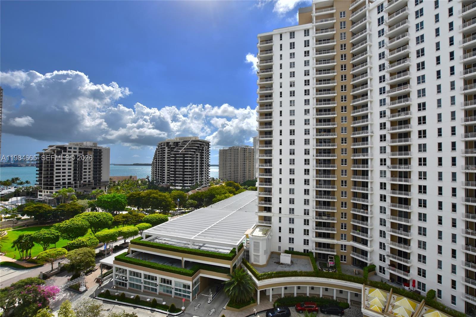 A view from a balcony overlooking a canal and high-rise buildings in a city — 801 Brickell Key Blvd # 1209, Miami FL 33131, MIAMI, FL