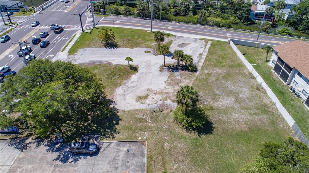 An aerial view shows a vacant, partially paved lot with several palm trees and trees — 2750 S RIDGEWOOD AVENUE, SOUTH DAYTONA, FL