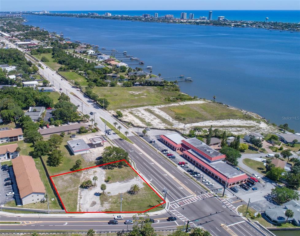 An aerial view shows a vacant, rectangular lot outlined in red next to a highway — 2750 S RIDGEWOOD AVENUE, SOUTH DAYTONA, FL