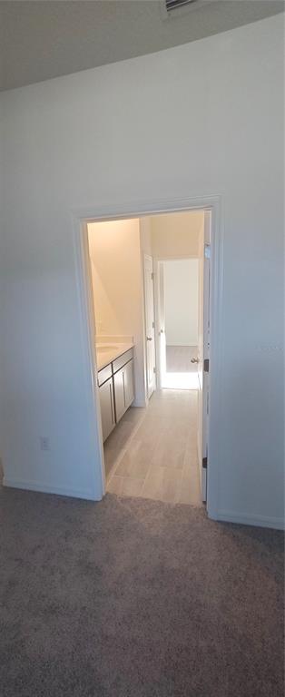 A doorway leads from a carpeted room into a bathroom with light-colored tile flooring — 51 KANKAKEE TRAIL, PALM COAST, FL