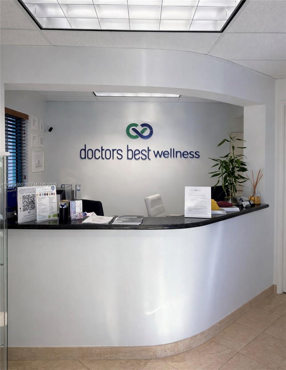 A reception desk with a company logo on the wall in a medical office — 2237 N Commerce Pkwy # 3, Weston FL 33326, WESTON, FL