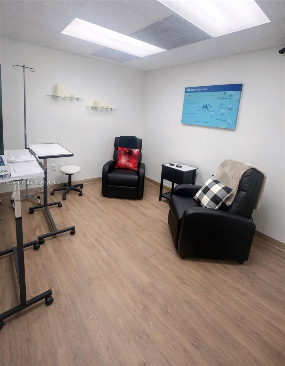 A medical treatment room features two black recliners, an IV stand, and light wood flooring — 2237 N Commerce Pkwy # 3, Weston FL 33326, WESTON, FL