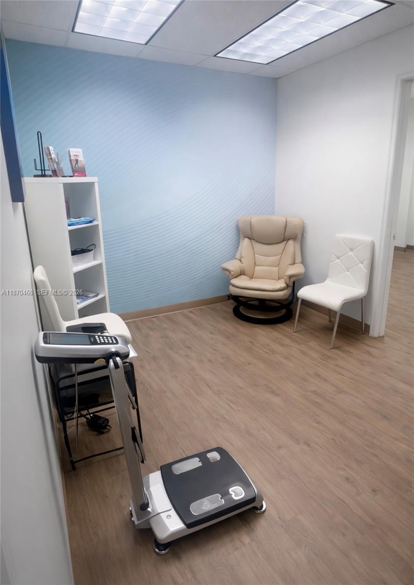 This medical office room features light wood flooring, a blue accent wall, and medical equipment — 2237 N Commerce Pkwy # 3, Weston FL 33326, WESTON, FL