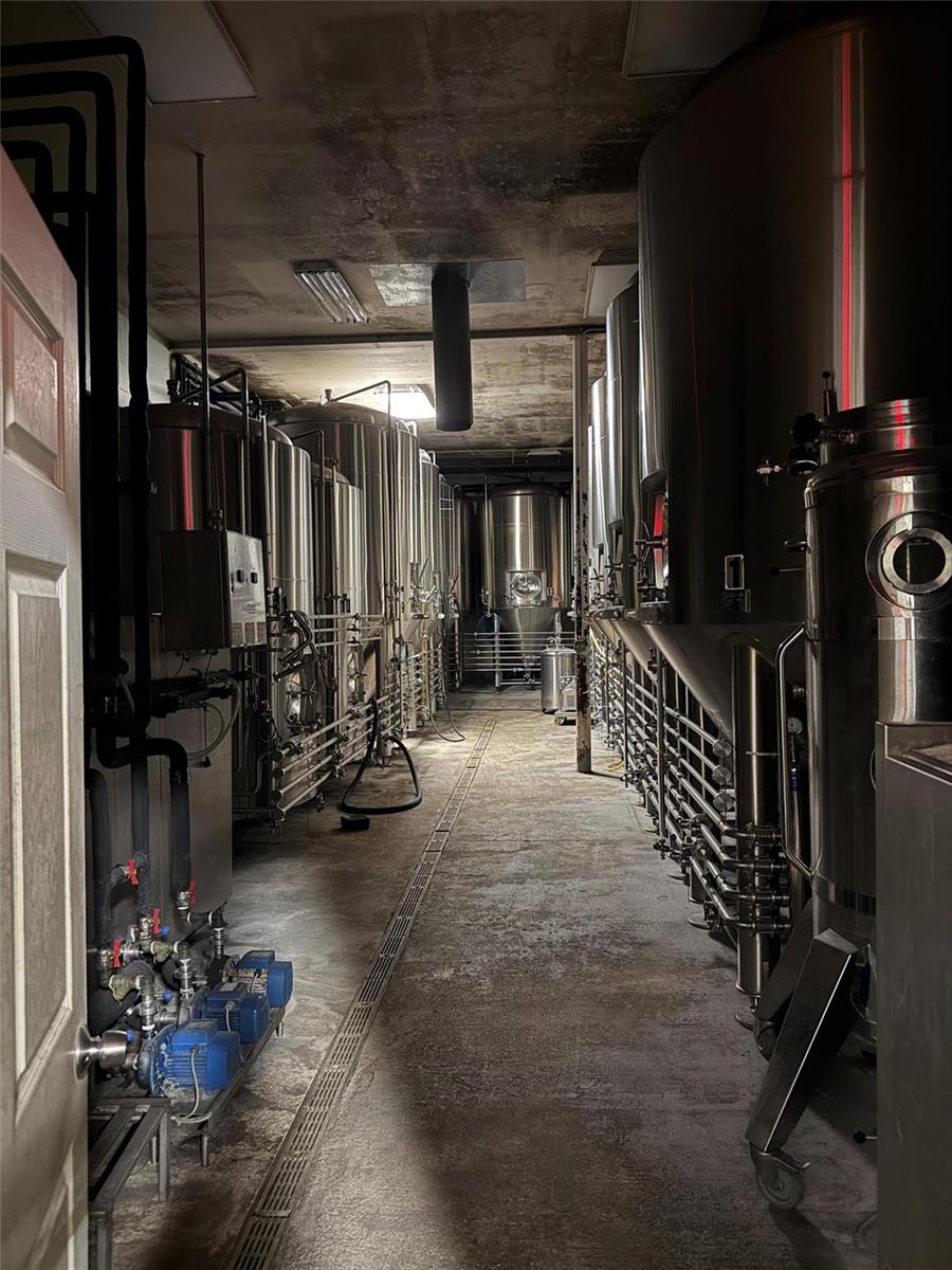 A narrow industrial room features rows of large stainless steel fermentation tanks and concrete flooring — 3410 29th Avenue, Hollywood FL 33020, HOLLYWOOD, FL