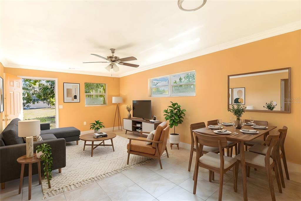 A living and dining room with orange walls, tile floors, and a ceiling fan — 140 AVENUE W NW UNIT 3, WINTER HAVEN, FL