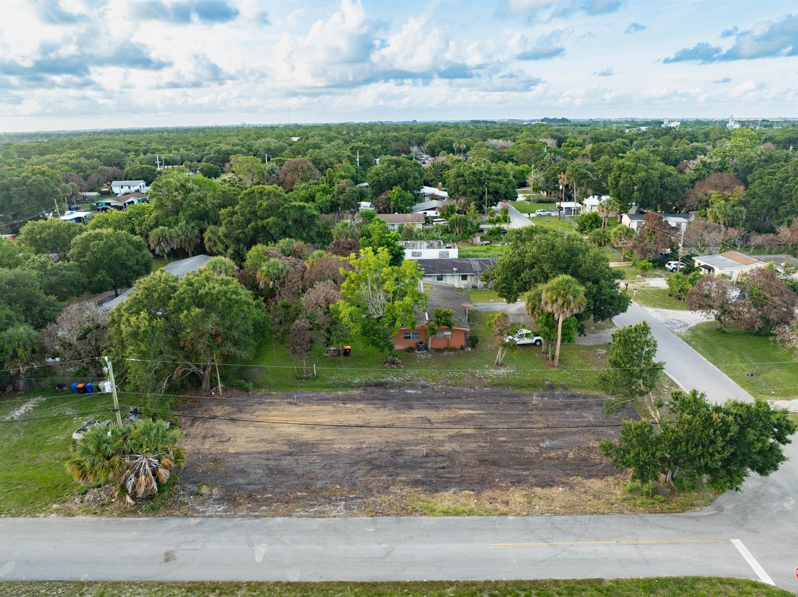 An aerial view shows a cleared, vacant rectangular lot adjacent to a residential house — 4805 34th Avenue, Vero Beach FL 32967, VERO BEACH, FL