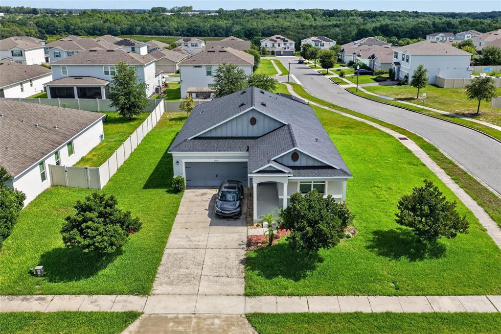 An aerial view of a single-story suburban house with a gray roof and driveway — 2364 CARRIAGE POINTE LOOP, APOPKA, FL