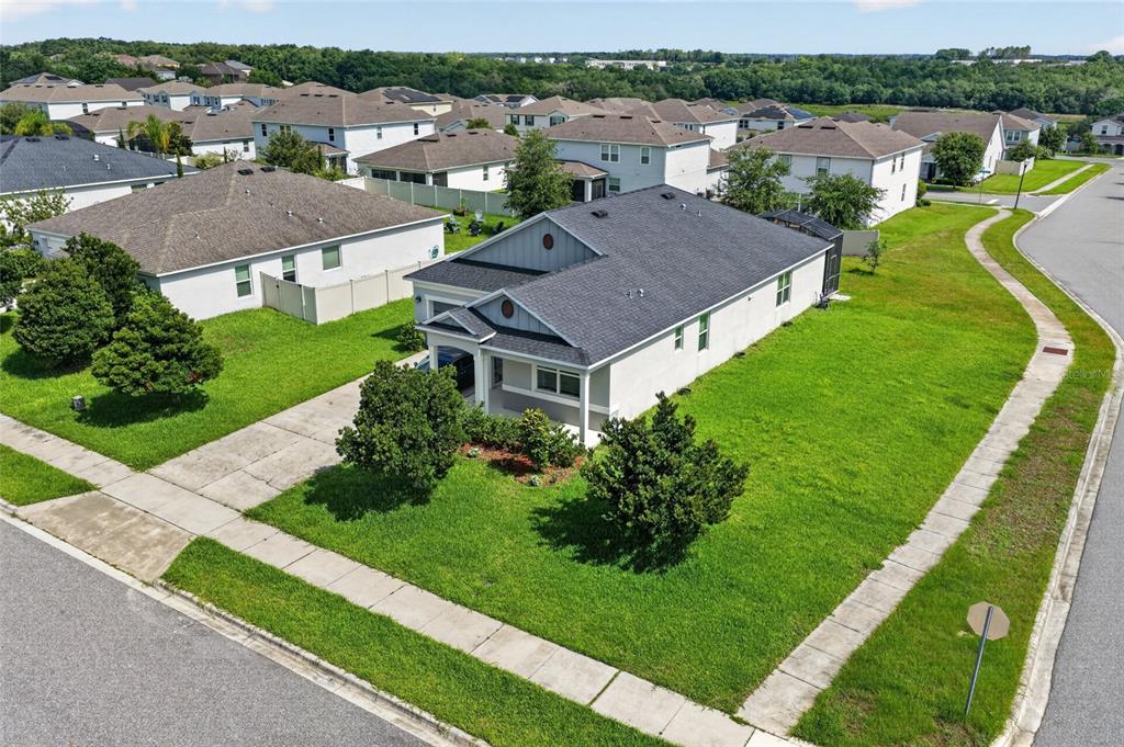 An aerial view of a suburban house with a gray roof and a concrete driveway — 2364 CARRIAGE POINTE LOOP, APOPKA, FL