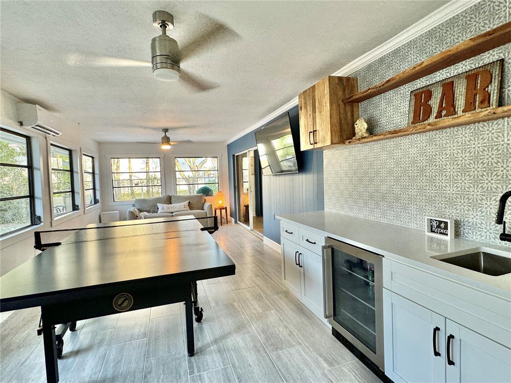A game room features a ping pong table, a wet bar, and tile flooring — 3409 45TH STREET W, BRADENTON, FL