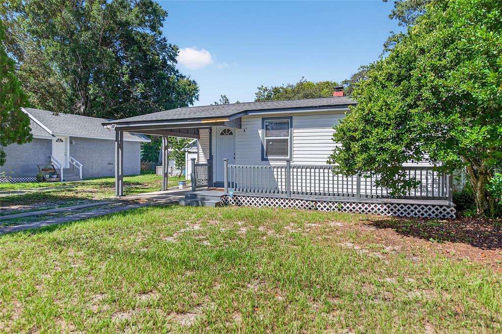 A single-story house with white siding, a front porch, and an attached carport — 1318 SAN JOSE BOULEVARD, DAYTONA BEACH, FL