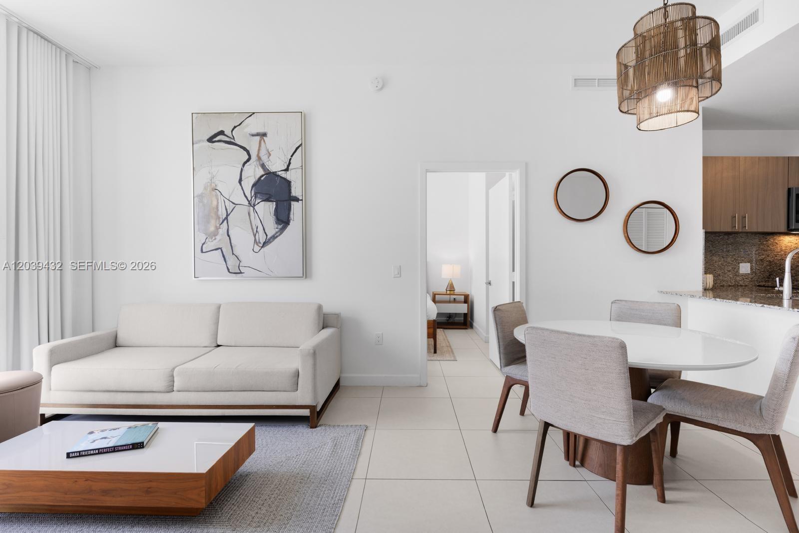 A modern living and dining area features white walls, tile flooring, and neutral furniture — 5350 NW 84th Ave # 2007, Doral FL 33166, DORAL, FL