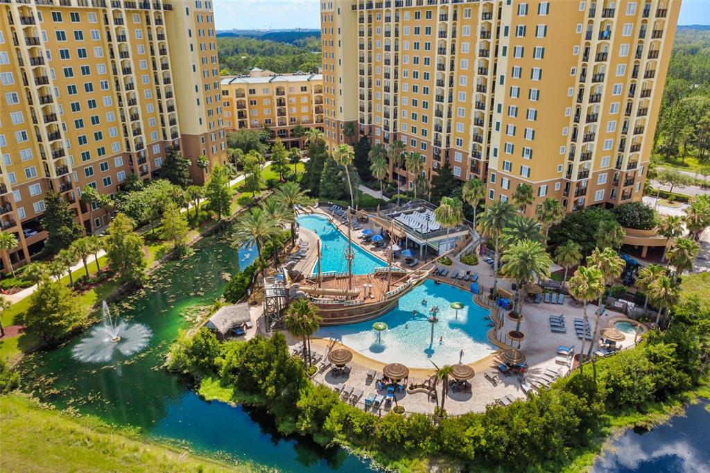 An aerial view of a large resort pool area featuring a pirate ship water feature — 8100 POINCIANA BOULEVARD UNIT 2505, ORLANDO, FL