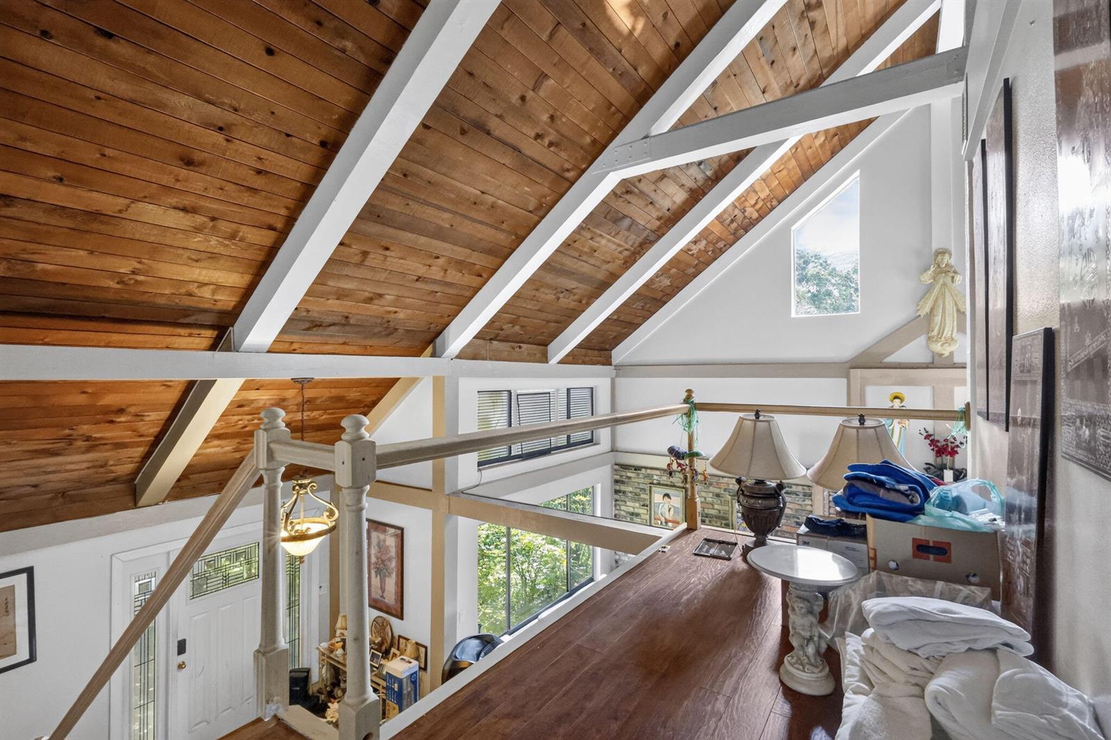 A loft area overlooks a living space with a vaulted wood-paneled ceiling and beams — 6022 Western Way, Lake Worth FL 33463, LAKE WORTH, FL
