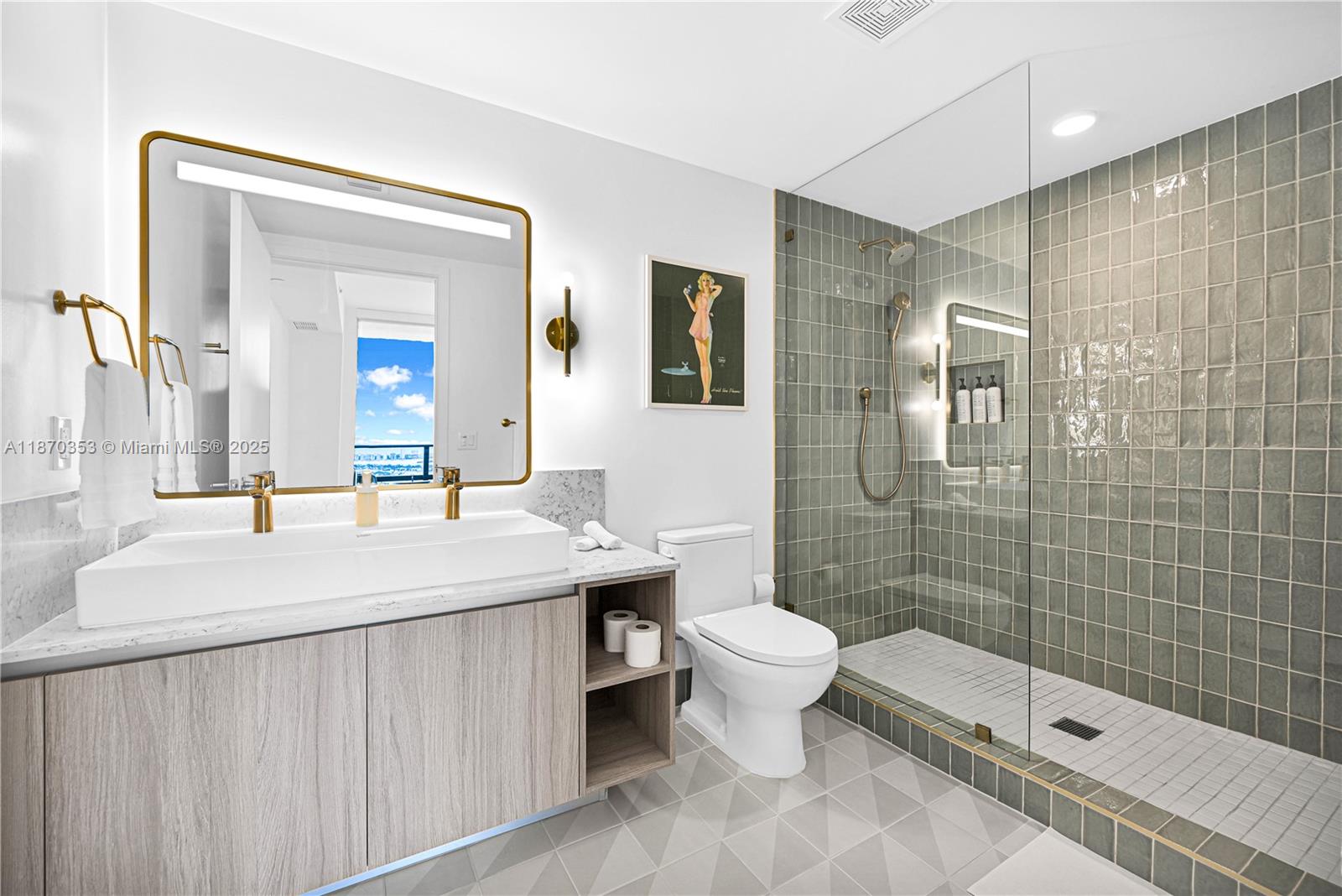 A modern bathroom features a wood vanity, gold fixtures, a glass shower, and gray tile — 159 NE 6th St # 4015, Miami FL 33132, MIAMI, FL