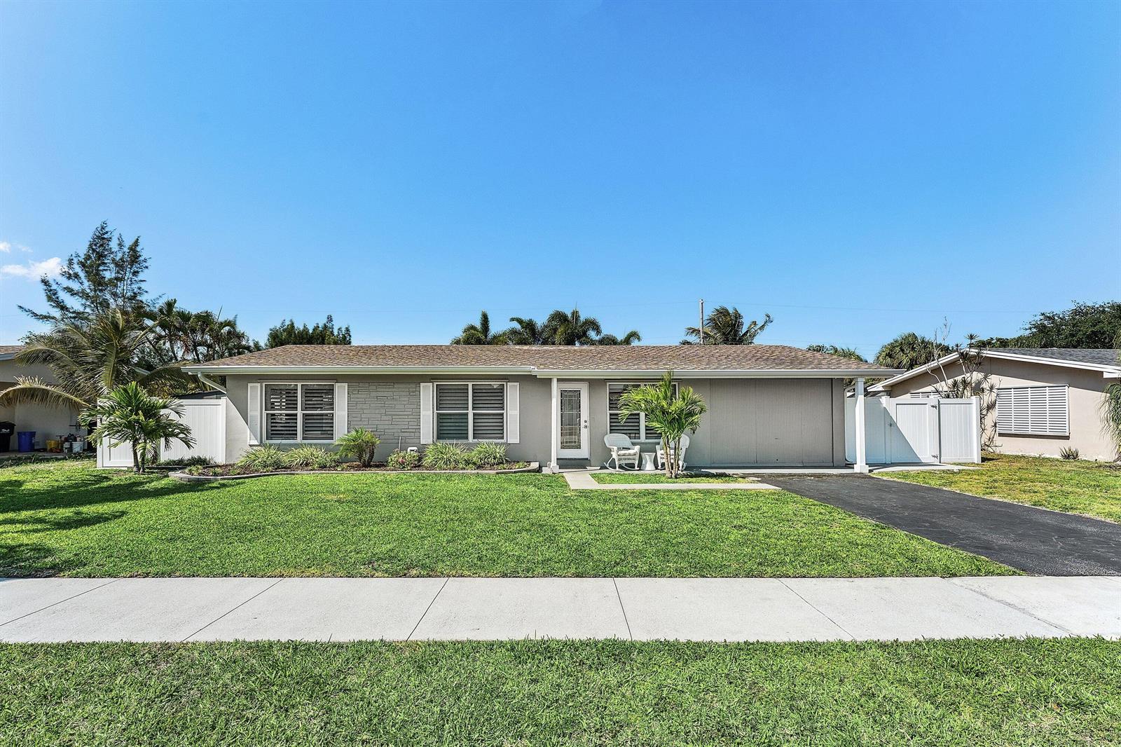 This floor plan shows a multi-bedroom home with two kitchens, multiple patios, and storage areas — 517 Ibis Drive, Delray Beach FL 33444, DELRAY BEACH, FL
